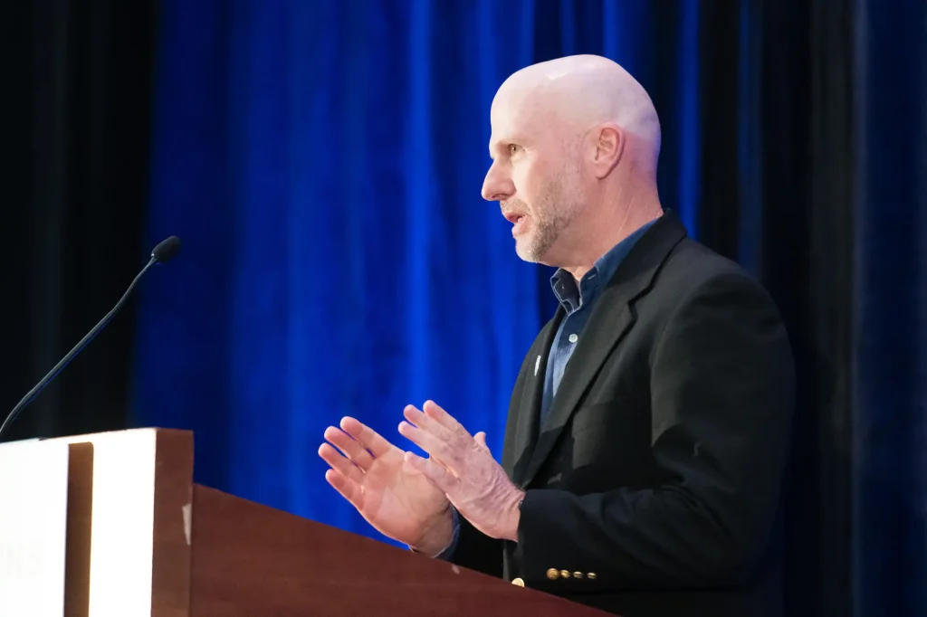 Darren Armstrong Speaking at Podium